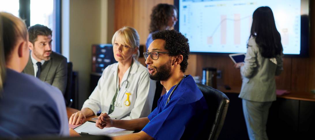 A group of people in a meeting

AI-generated content may be incorrect.